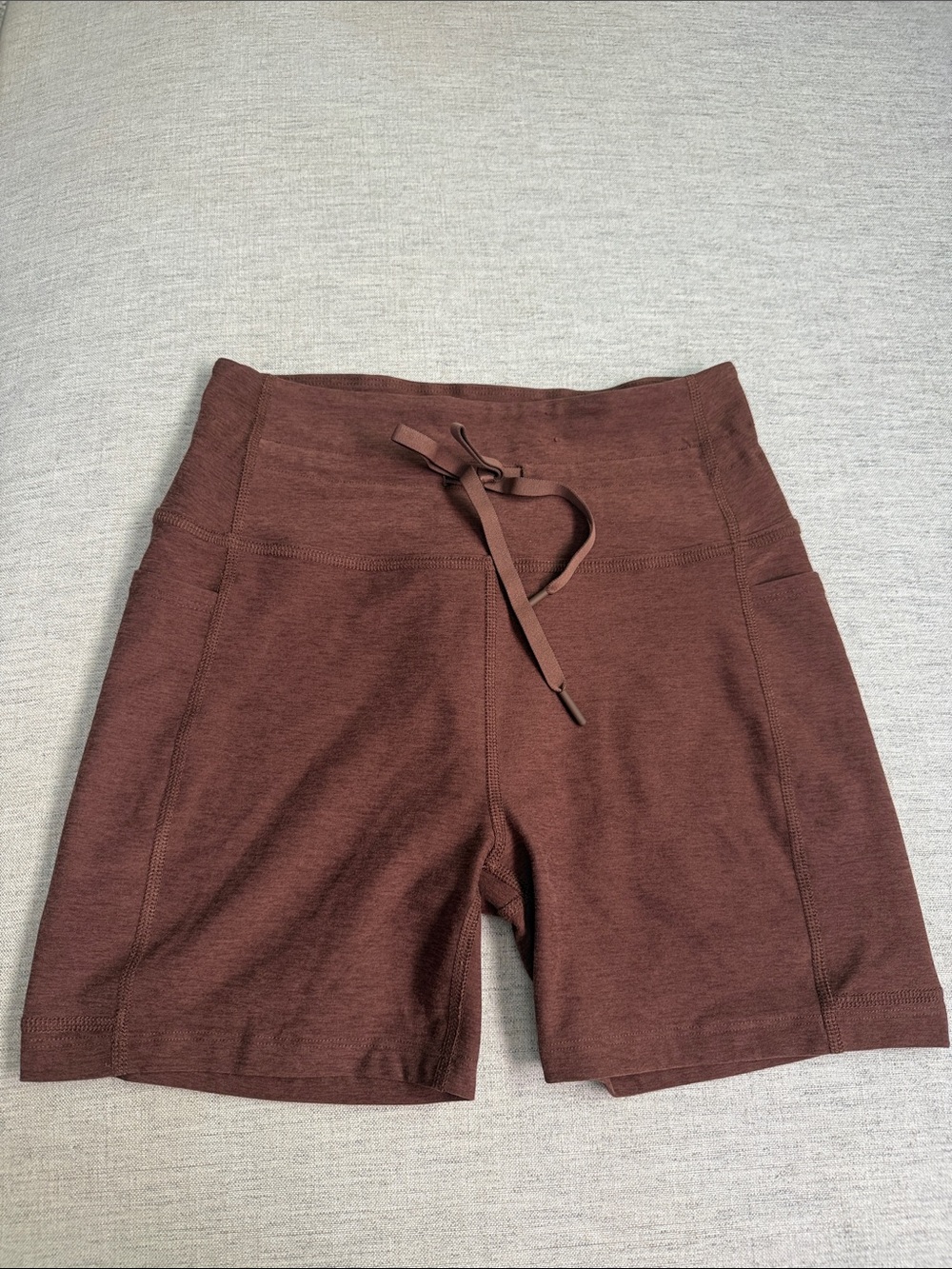 Beyond Yoga High-Rise Drawstring Bike Shorts in Brown Side Pockets